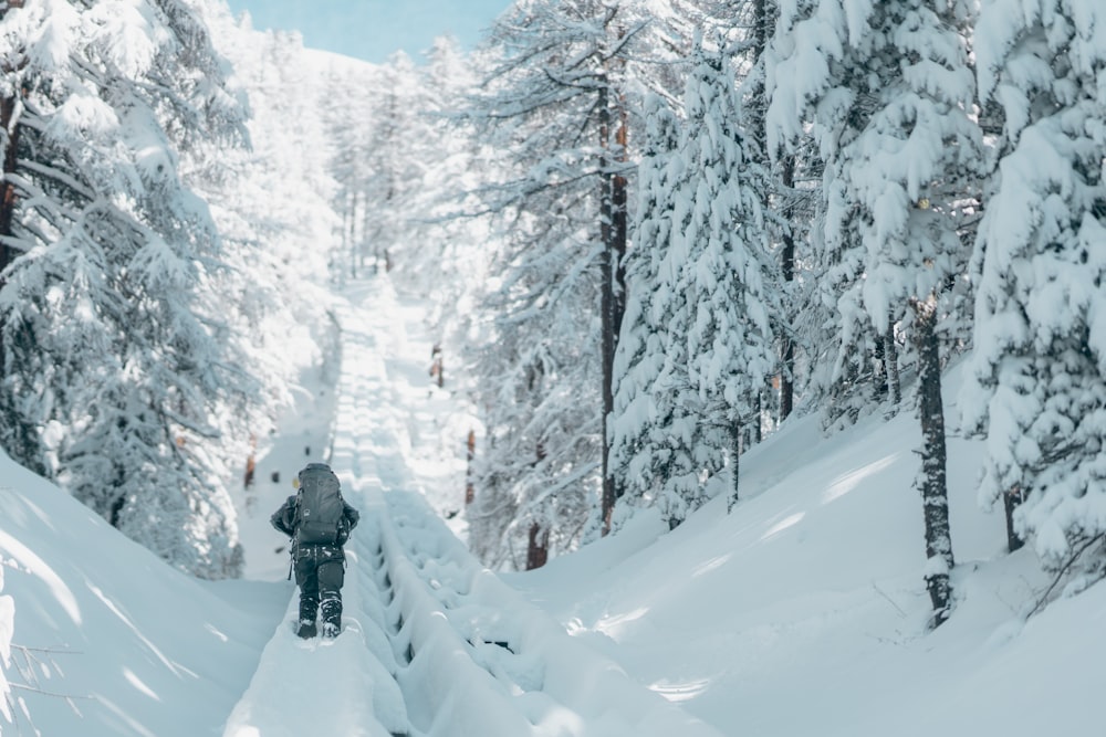 a man riding skis down a snow covered slope