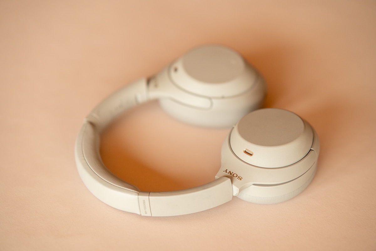 A pair of white headphones sitting on top of a table