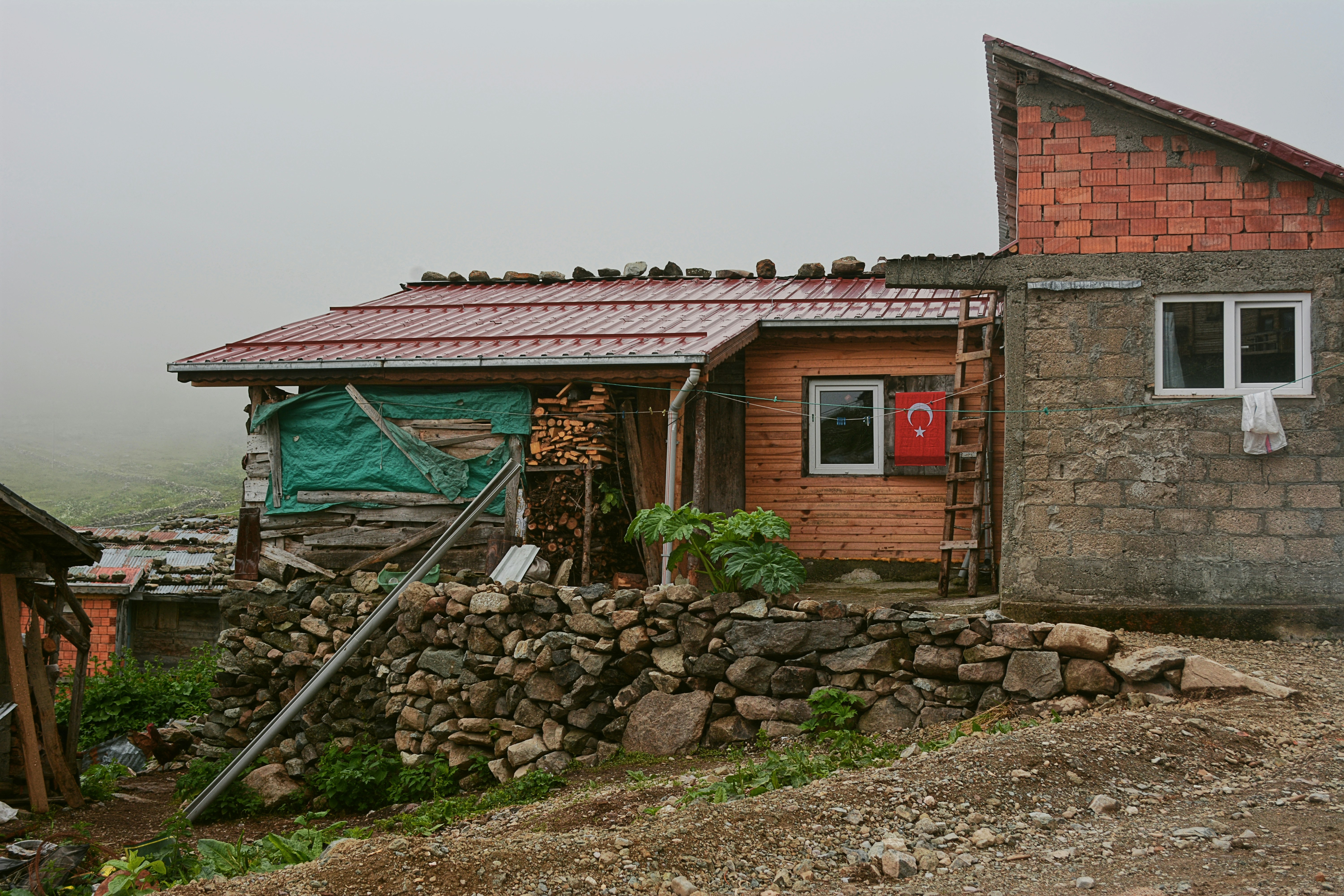 a small wooden house with a red door