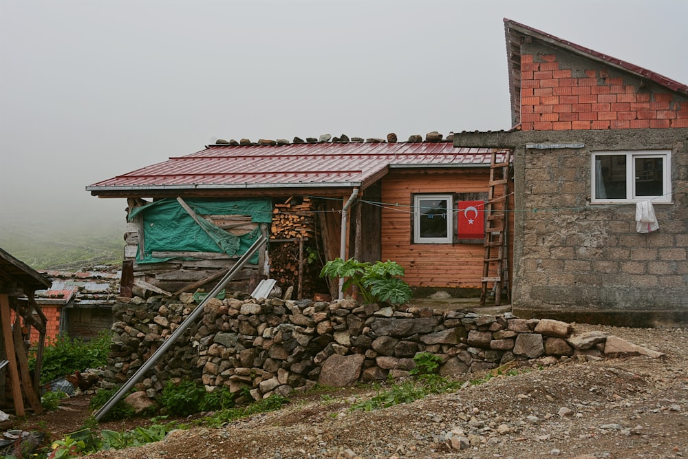 a small wooden house with a red door