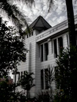 a white building with a clock on the front of it