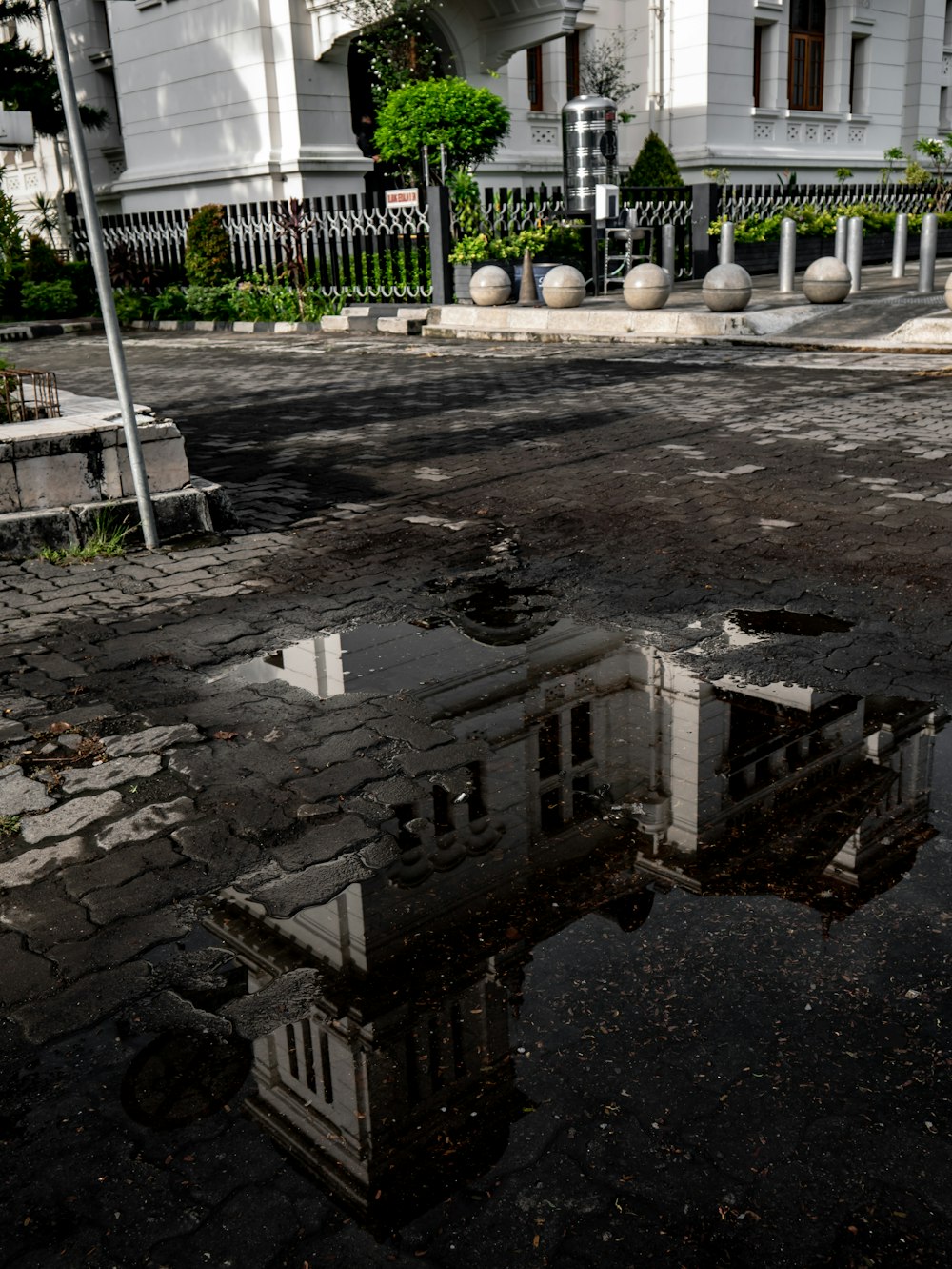 a reflection of a building in a puddle of water