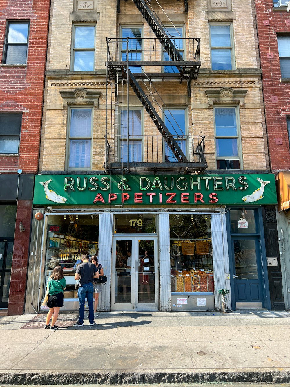 a couple of people standing outside of a building