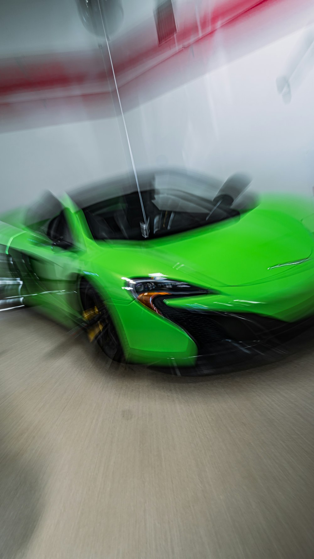 a green sports car driving down a street