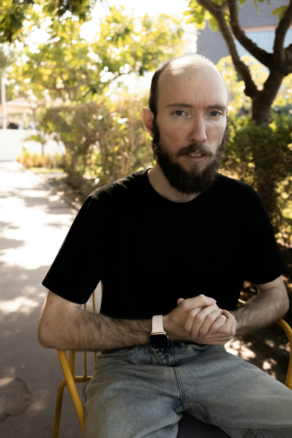 a man with a beard sitting in a chair