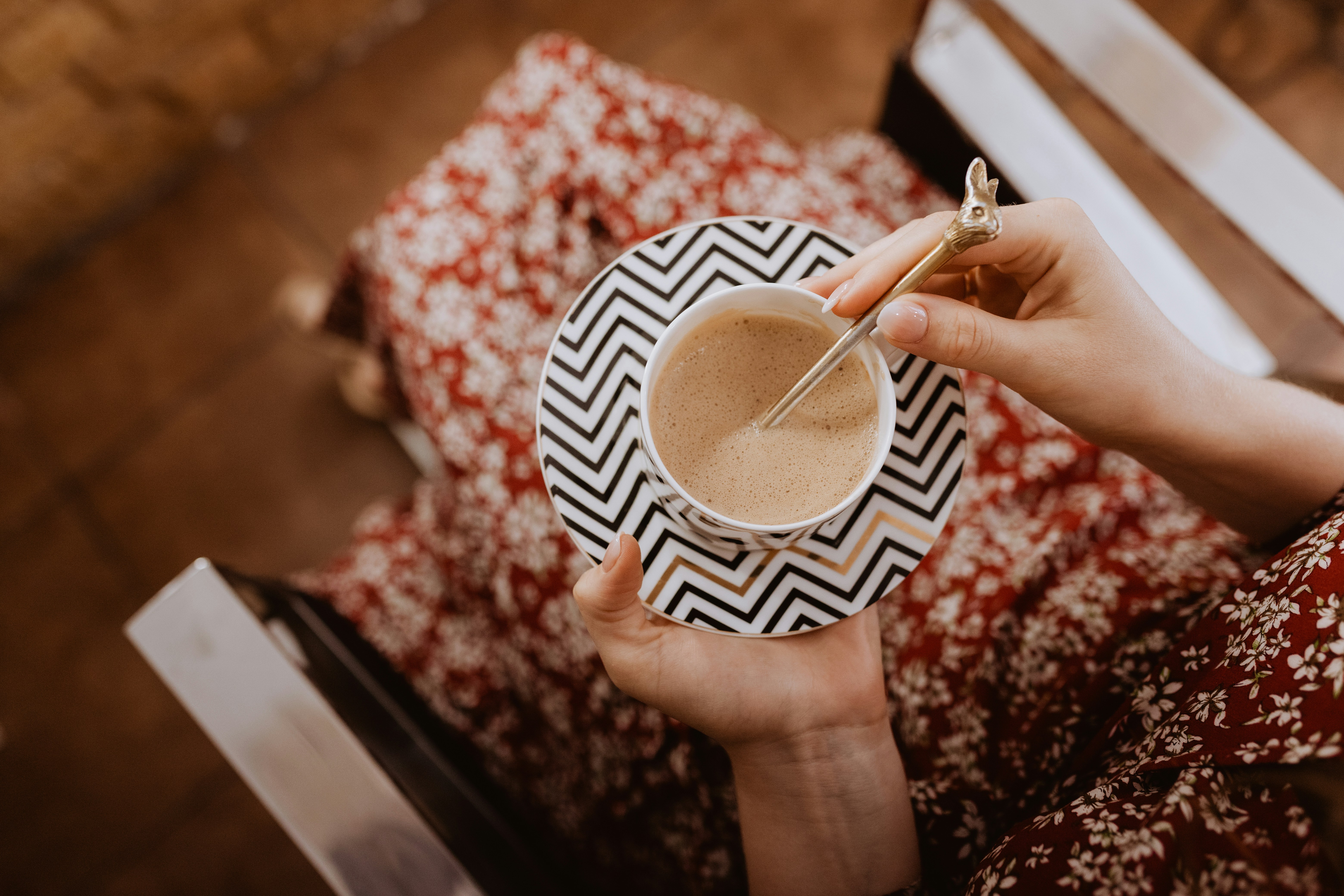 a woman is holding a cup of coffee