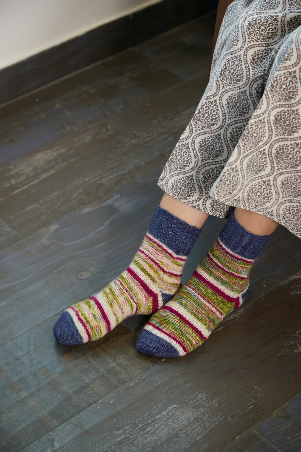 a close up of a person wearing colorful socks