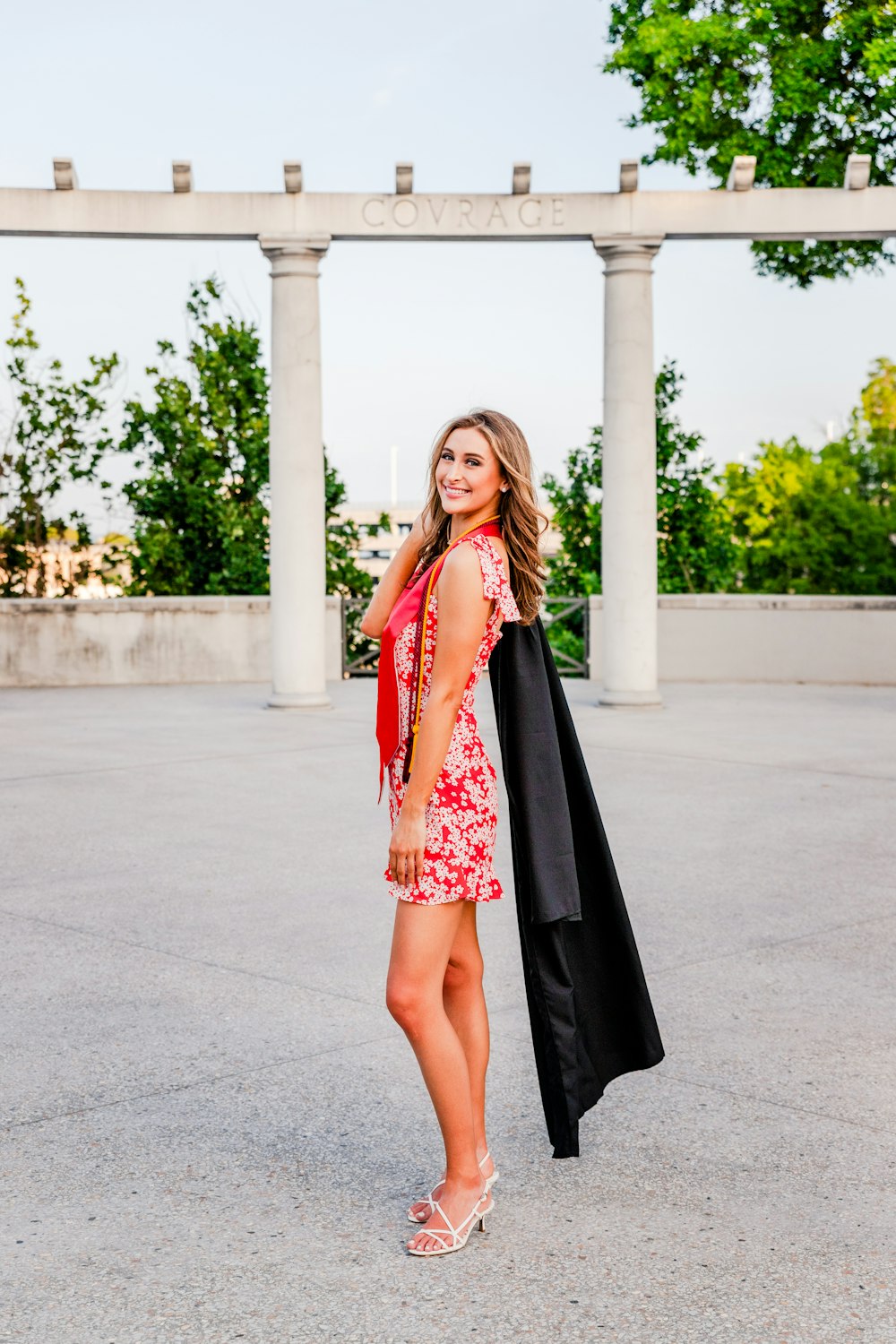 a woman in a red and black dress posing for a picture