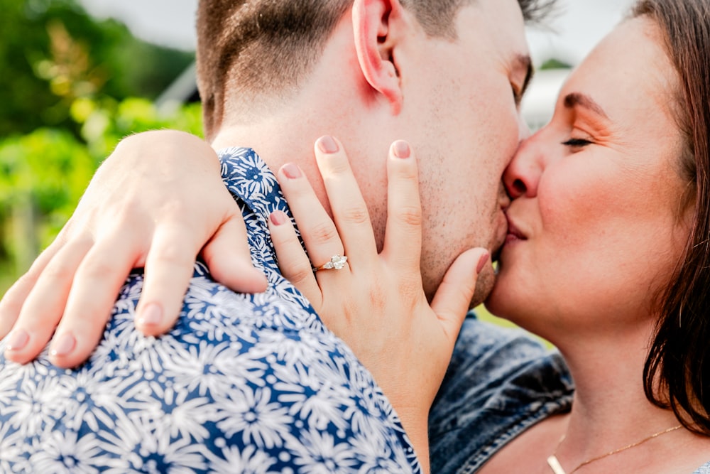 a man and a woman kissing each other