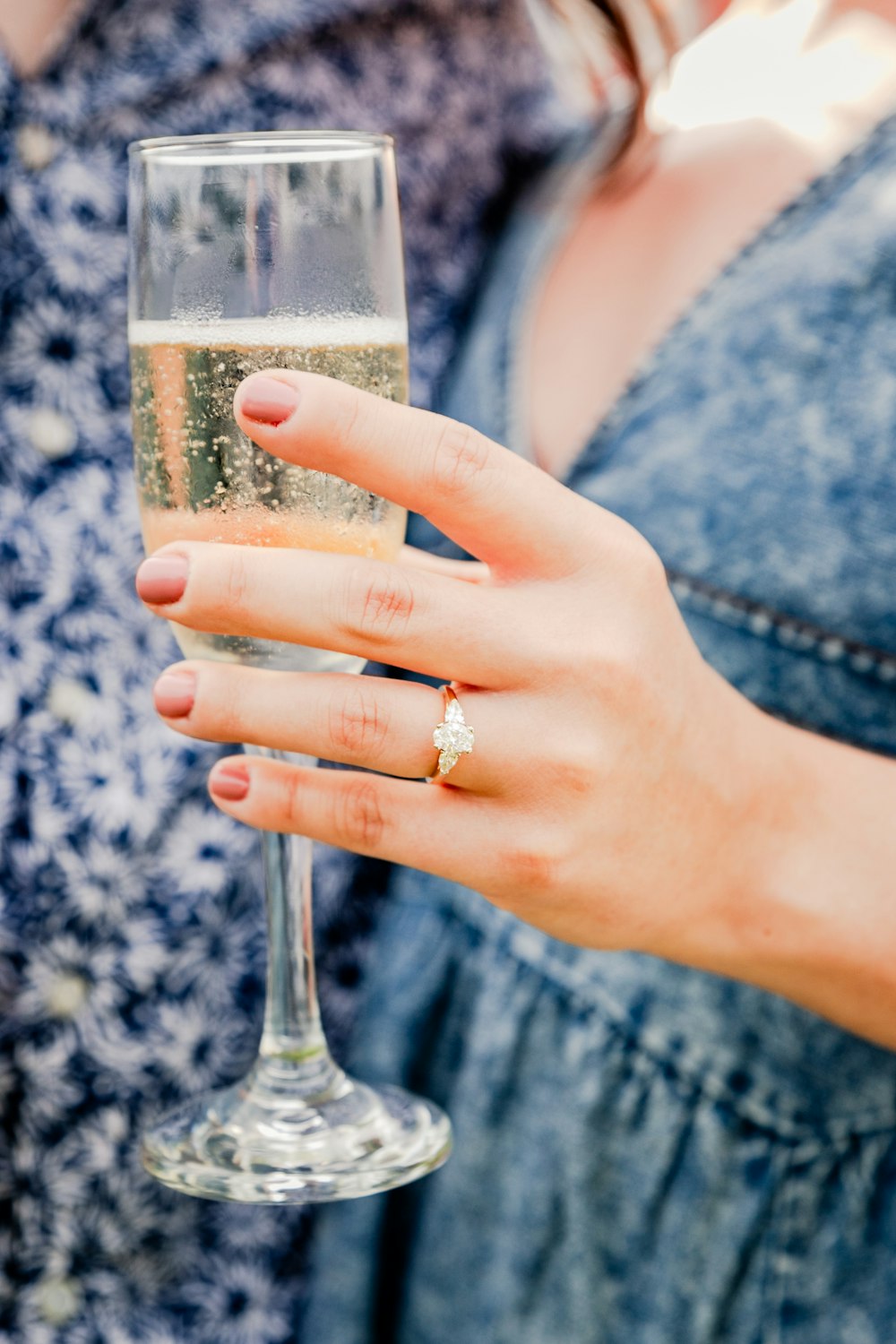 a close up of a person holding a wine glass