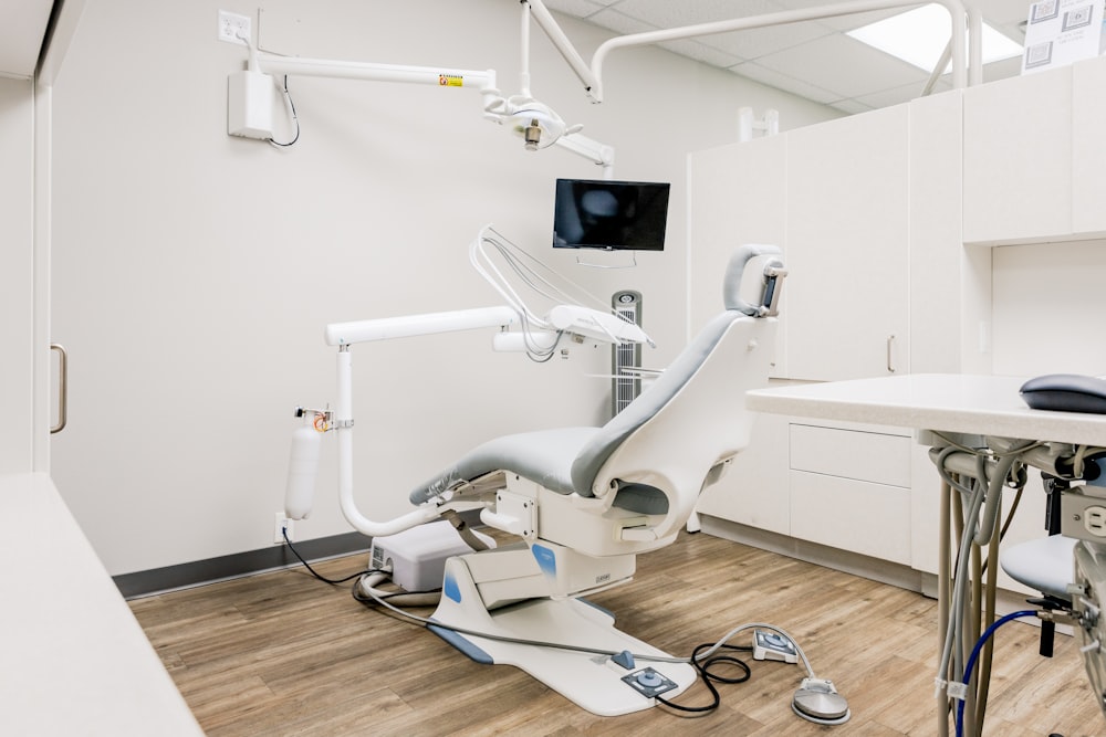a dental room with a desk and chairs