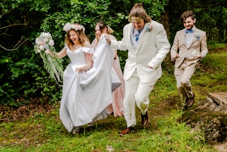 a group of people that are walking in the grass