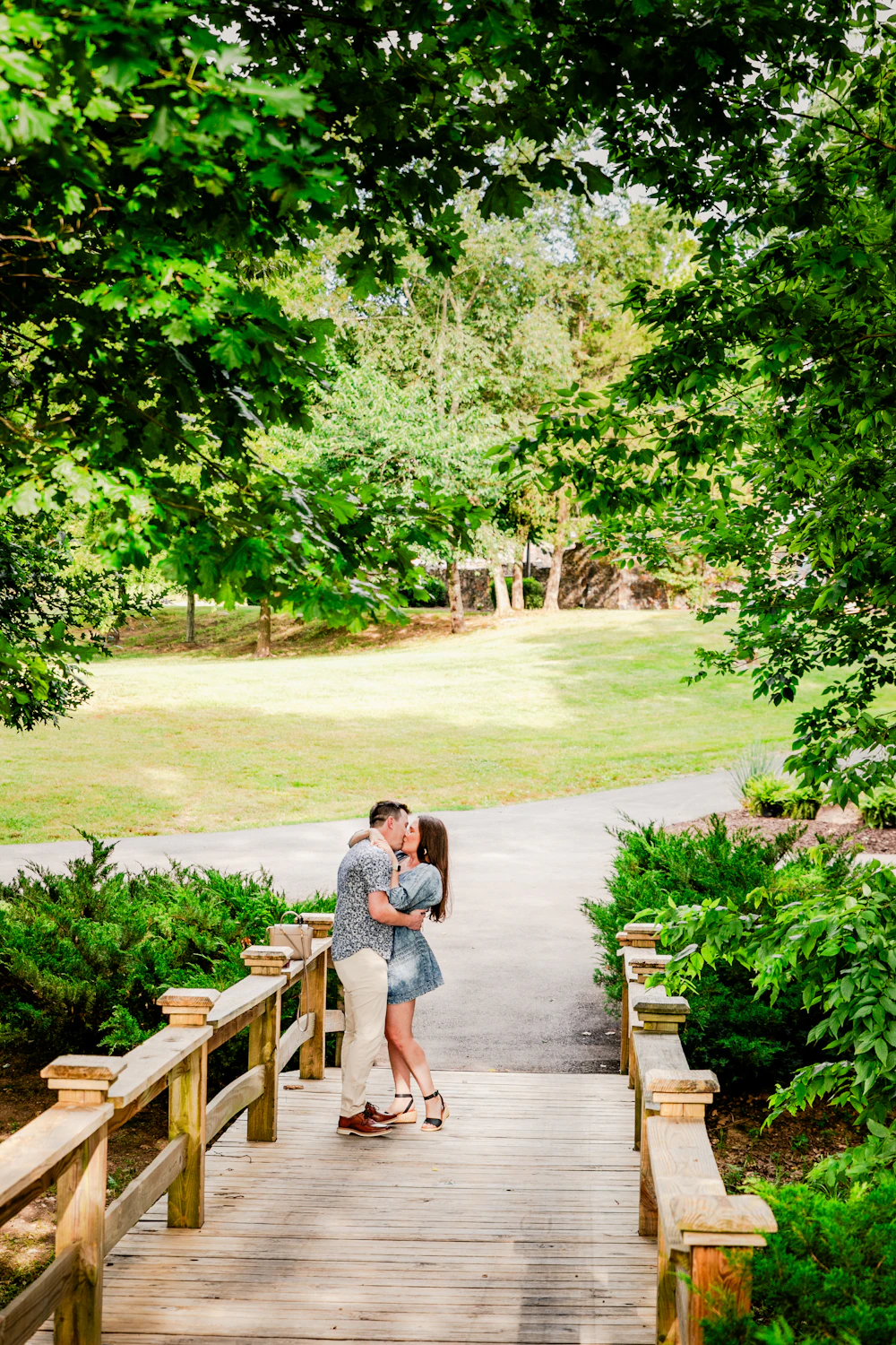 Couple embracing on a bridge in a park