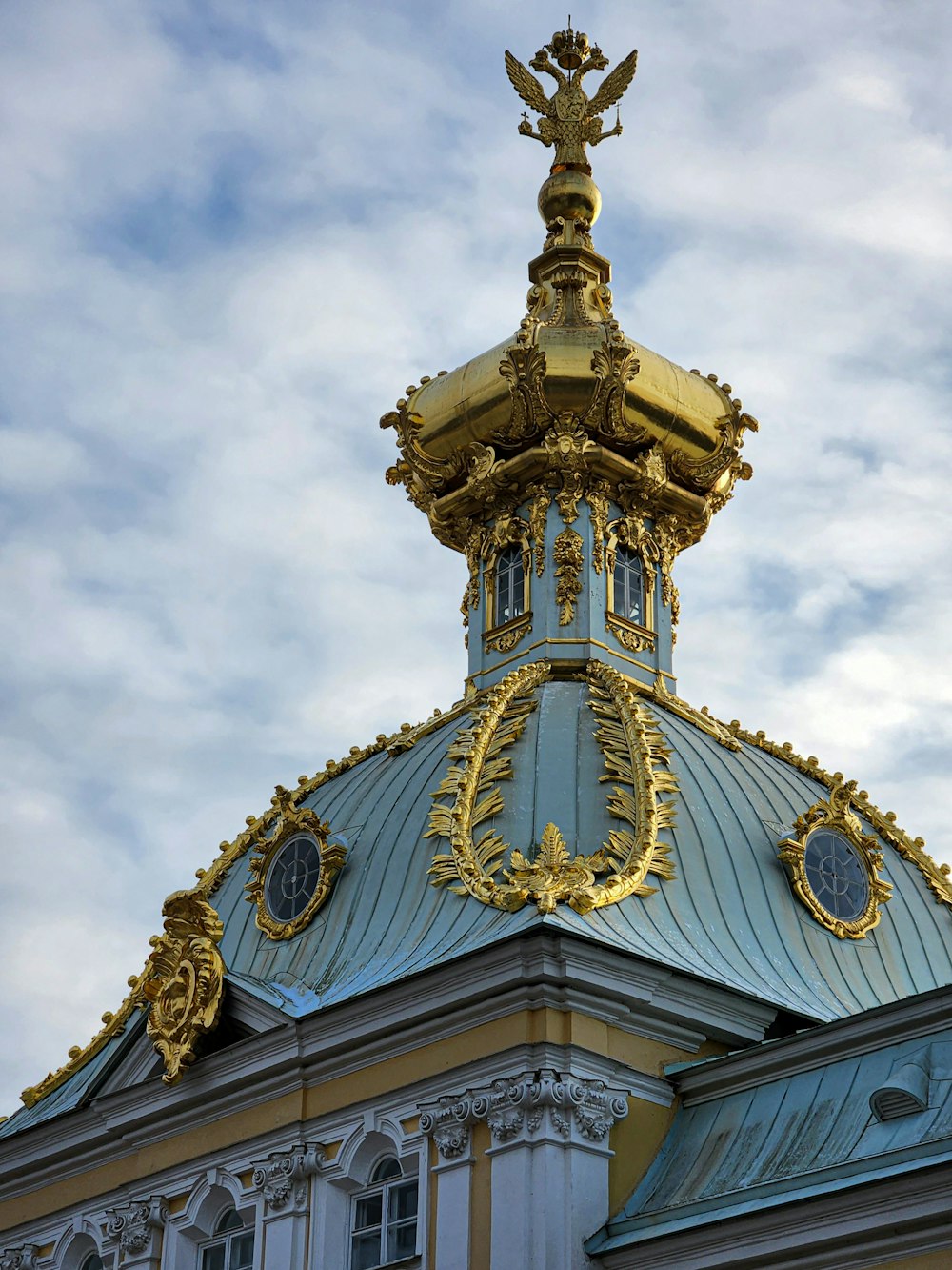 a gold and blue building with a clock on top