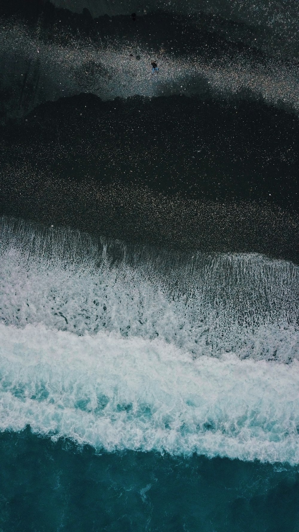 a person riding a surfboard on top of a wave