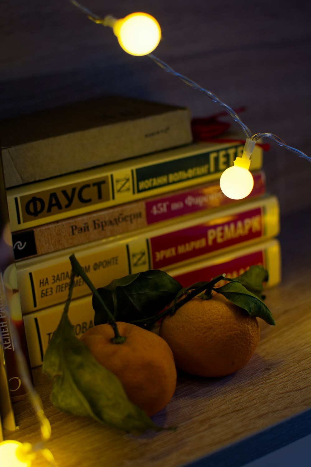 a pile of books sitting on top of a wooden table