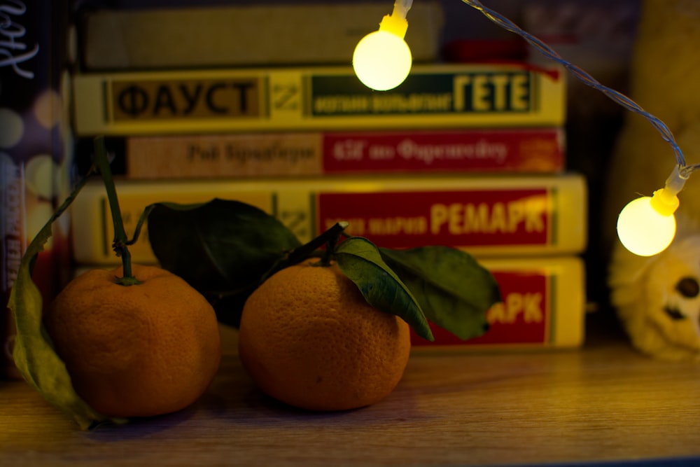 a couple of oranges sitting on top of a table