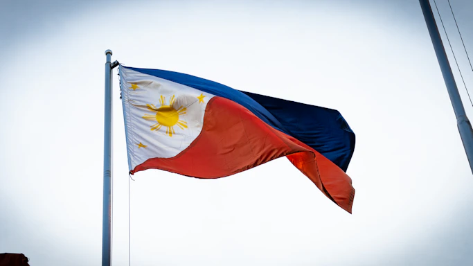 a flag flying in the wind on a pole