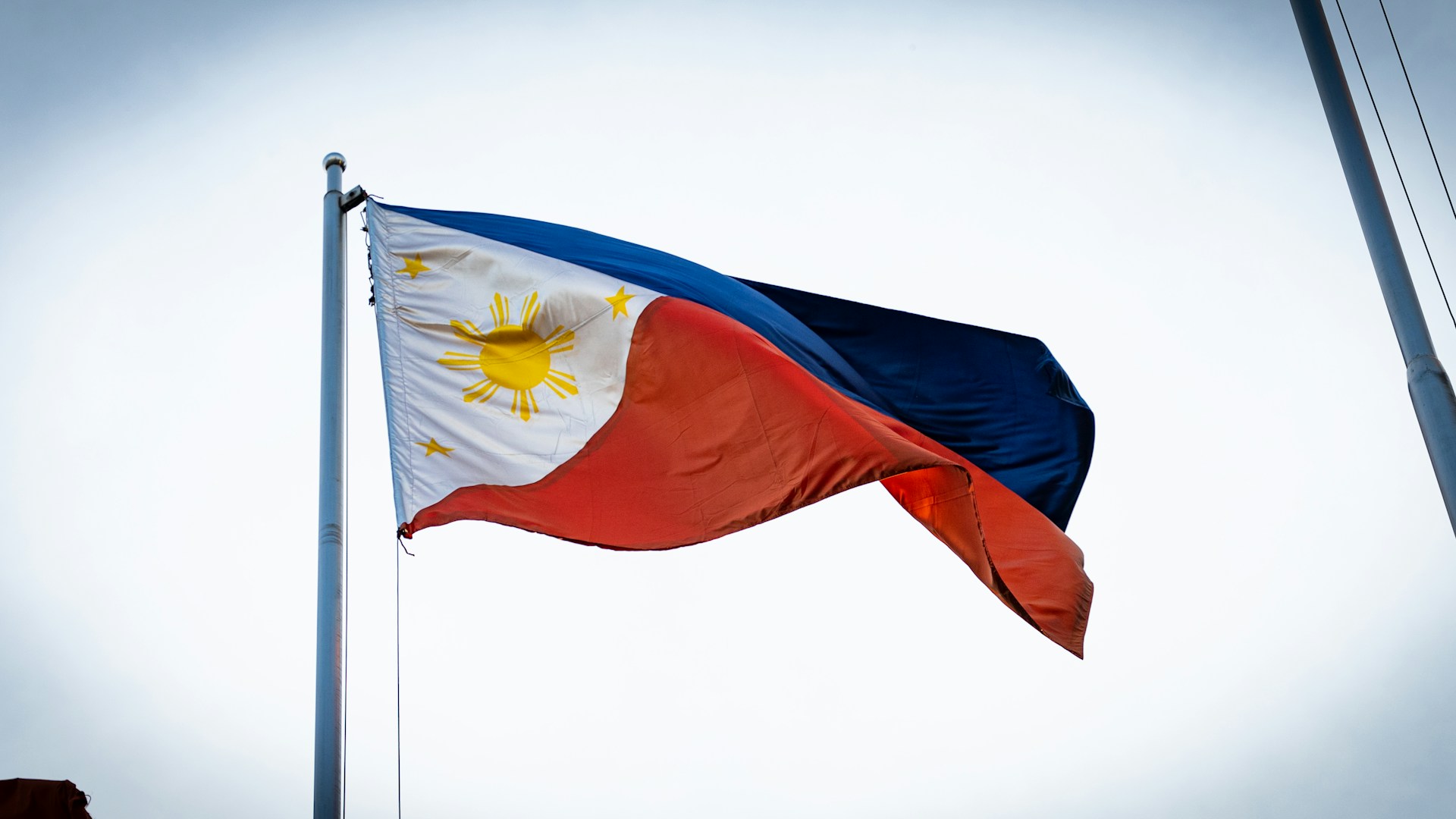 a flag flying in the wind on a pole
