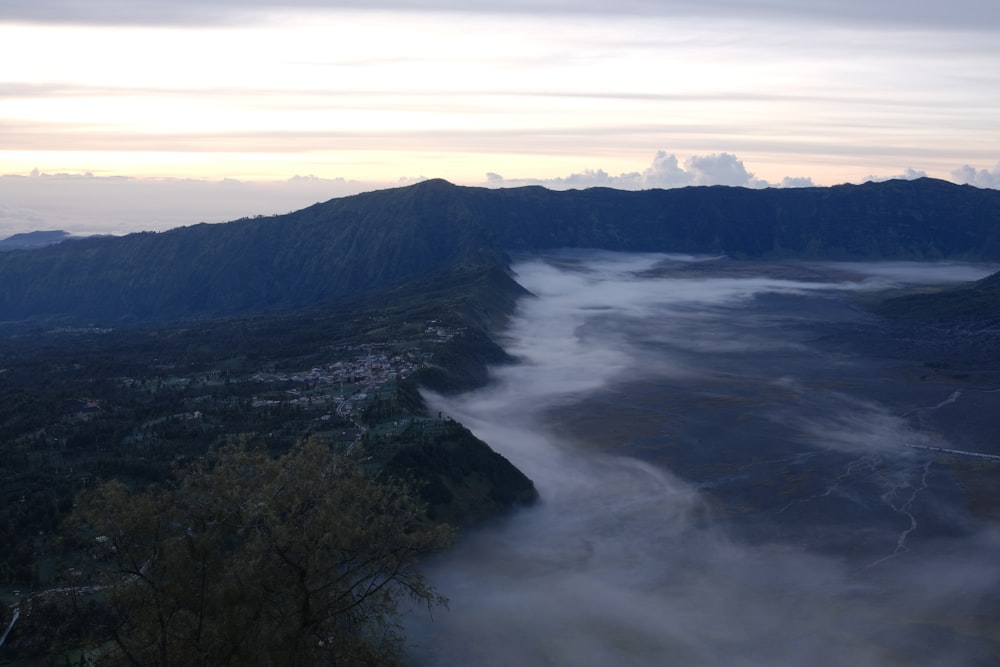 a view of a valley with low lying clouds