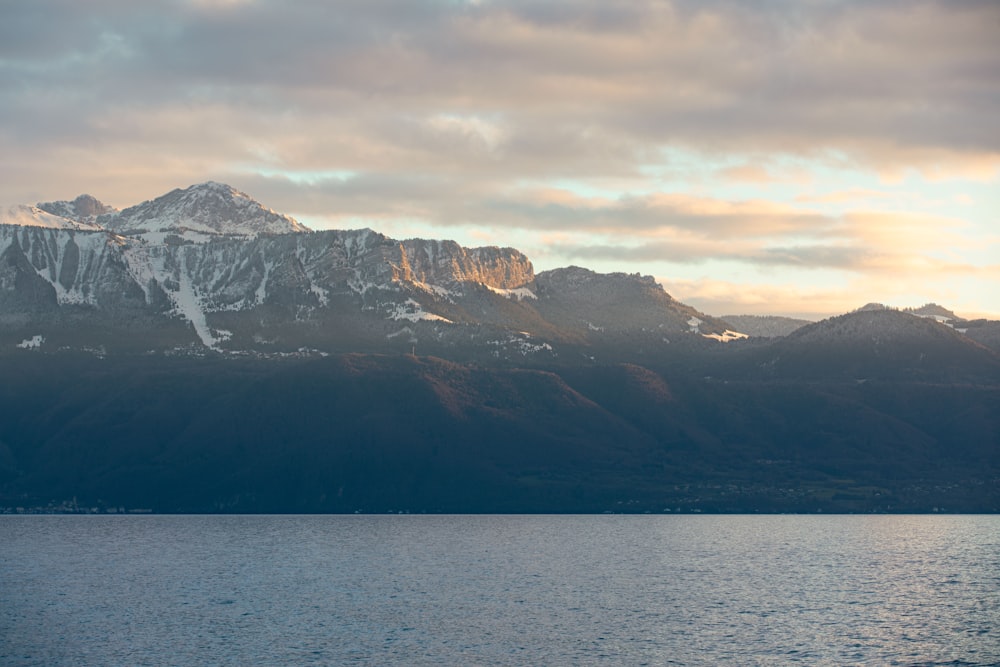 a large body of water with mountains in the background