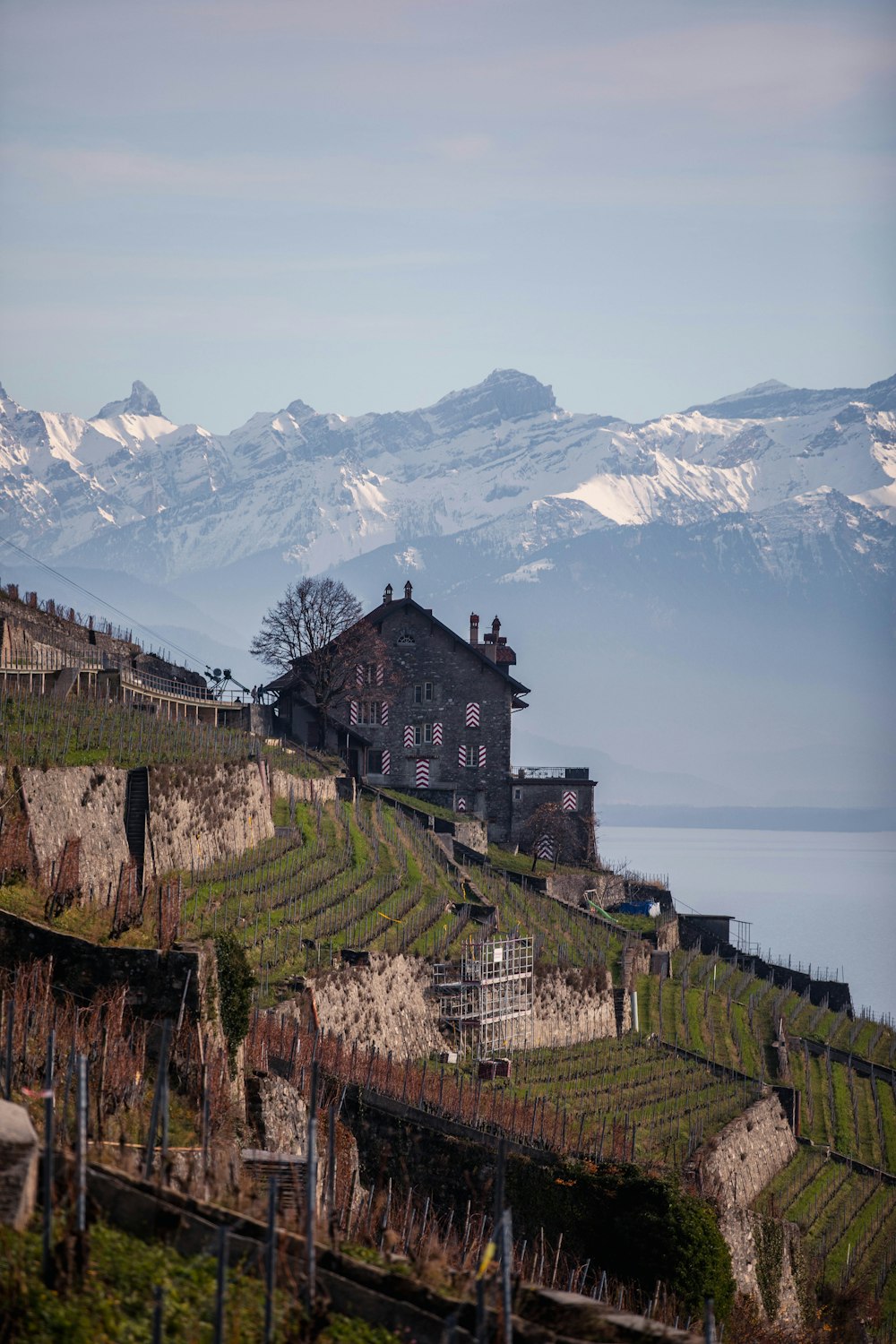 a house on a hill with mountains in the background