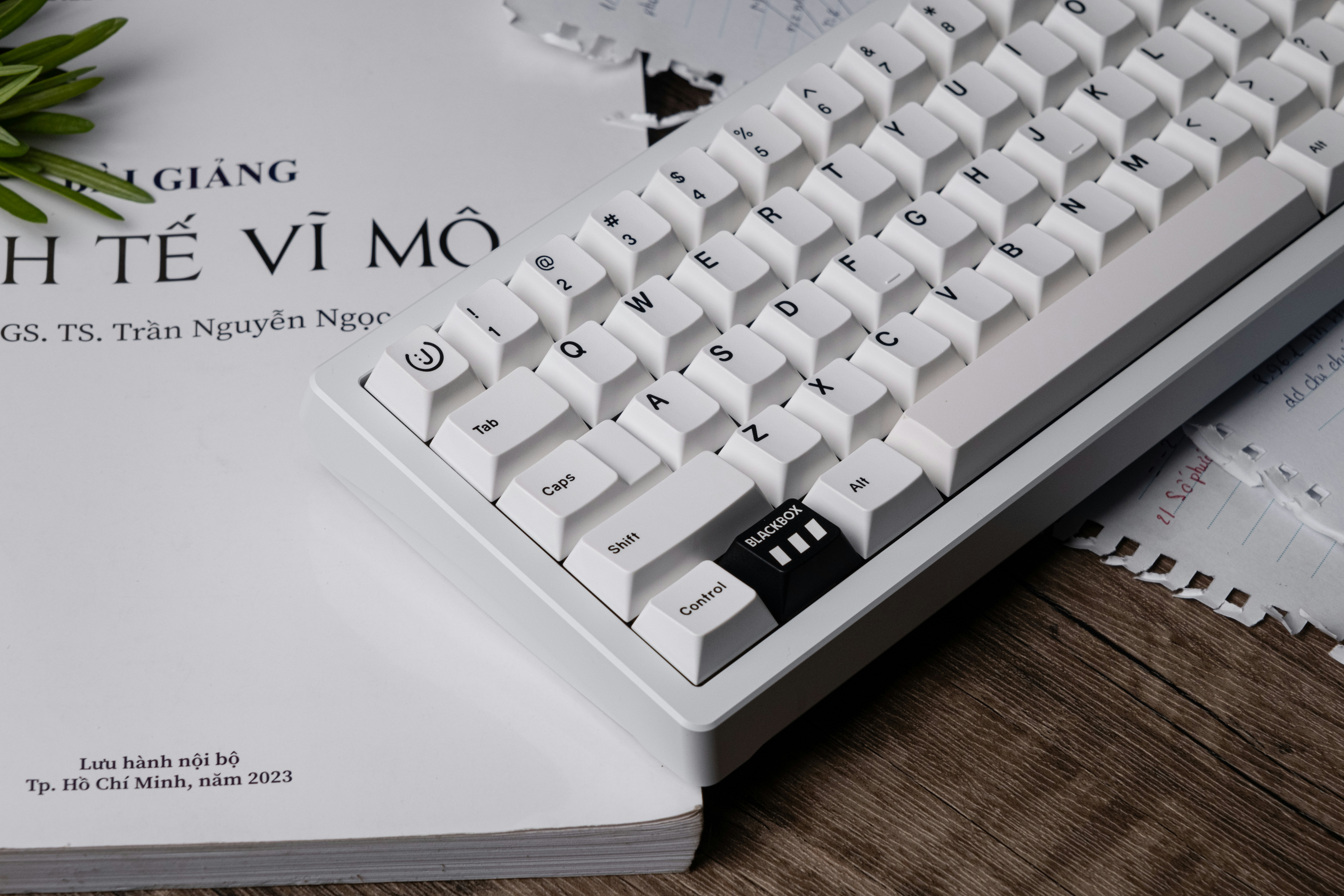 a white keyboard sitting on top of a book