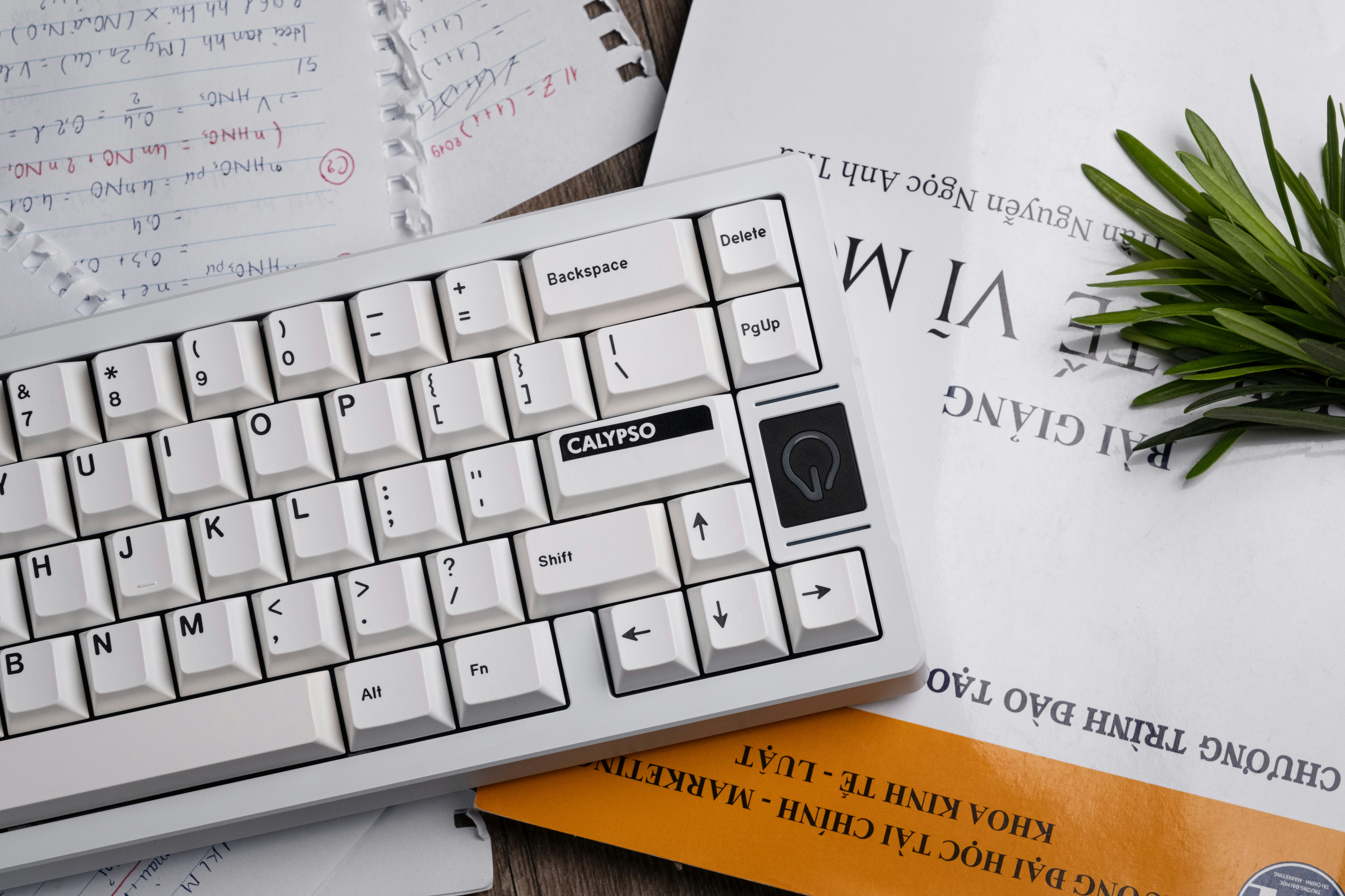 a computer keyboard sitting on top of a wooden table