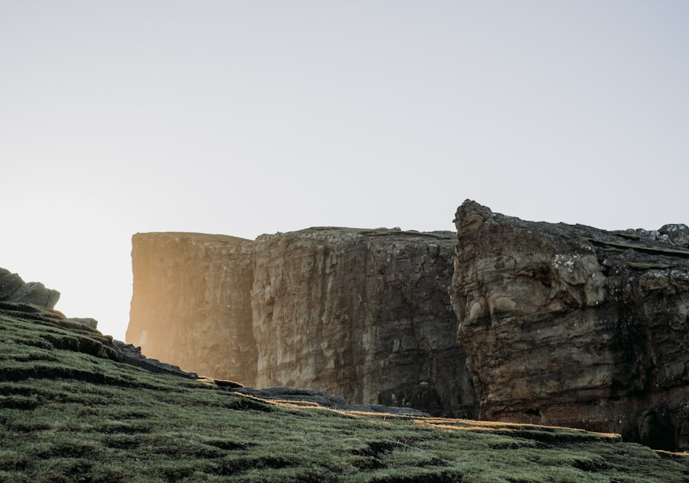 a person standing on top of a grass covered hill