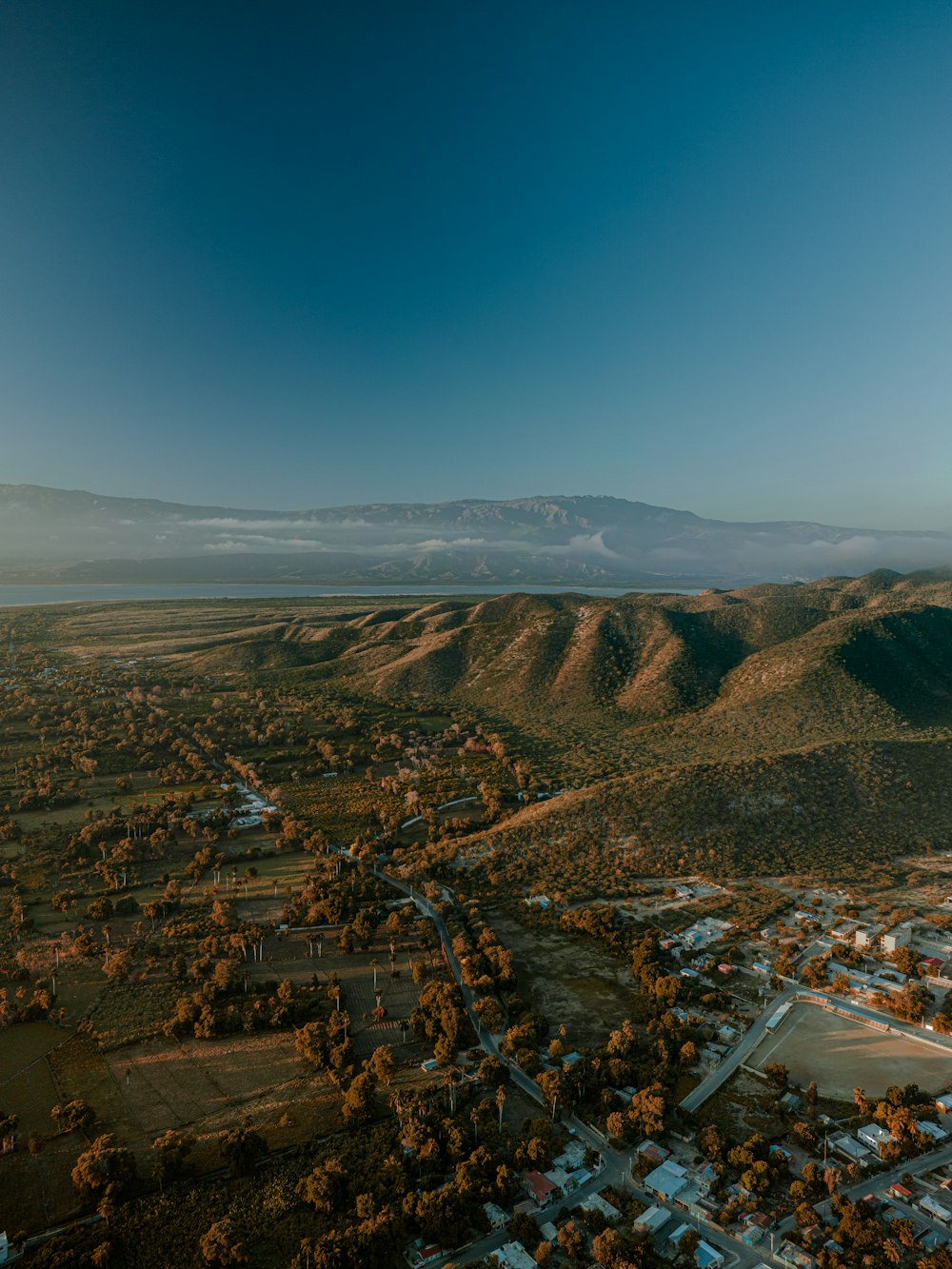 an aerial view of a town and mountains