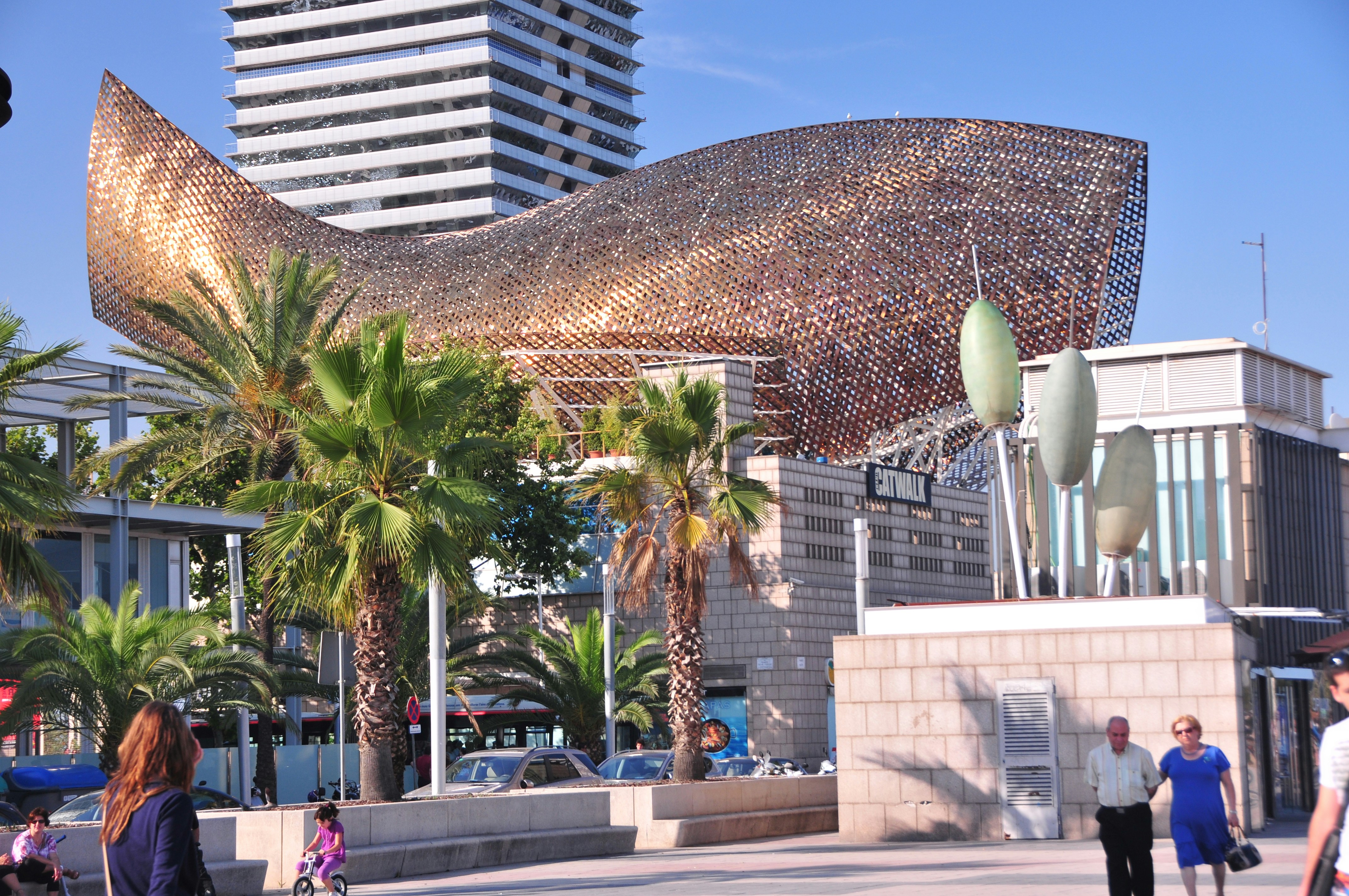 a sculpture of a giant fish in front of a building