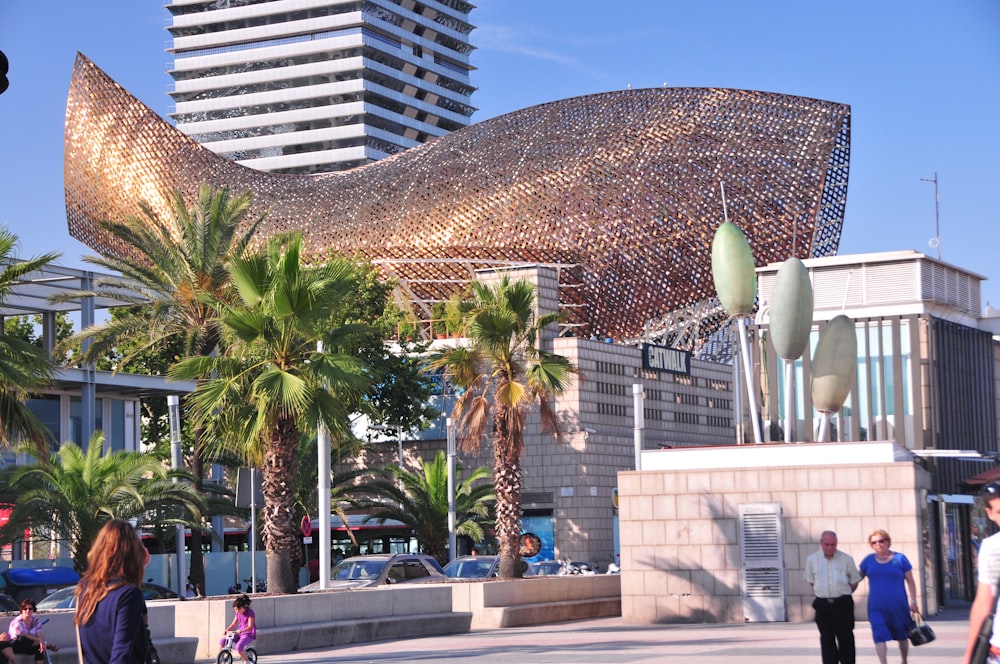 a sculpture of a giant fish in front of a building