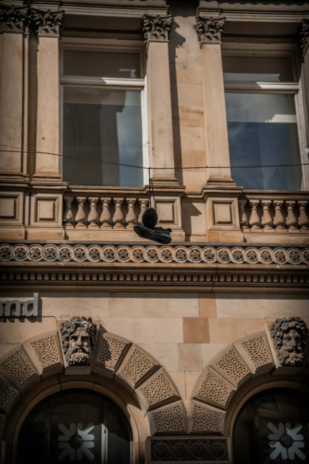 a bird is perched on the corner of a building