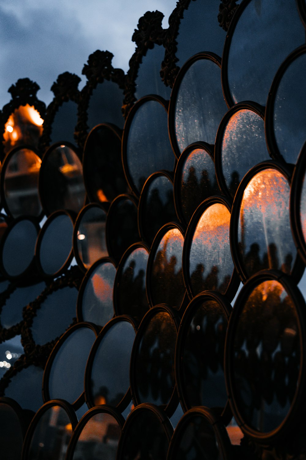 a close up of a mirror with a sky in the background