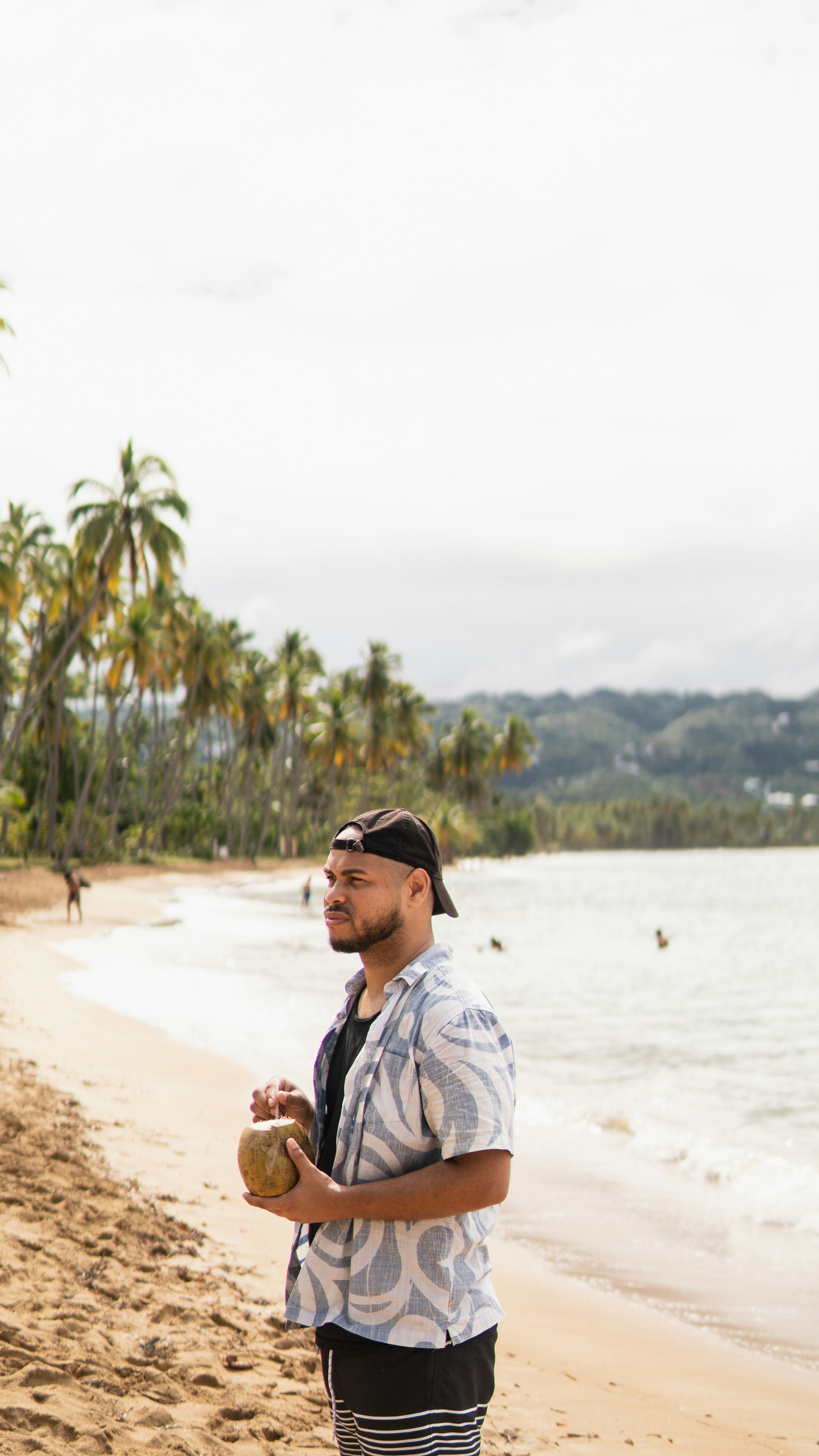a man standing on a beach next to the ocean
