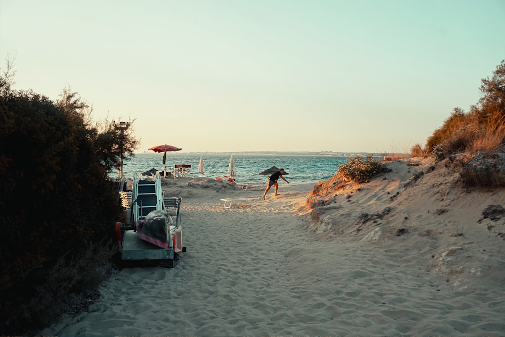 a beach scene with people walking on the sand