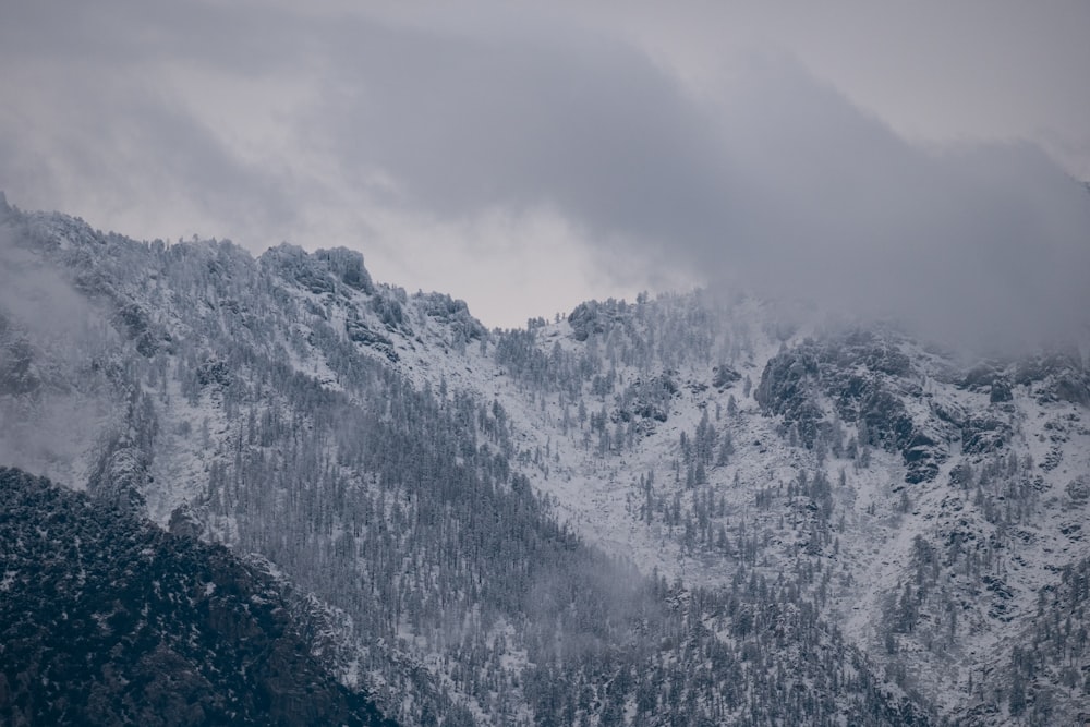 a mountain covered in snow on a cloudy day