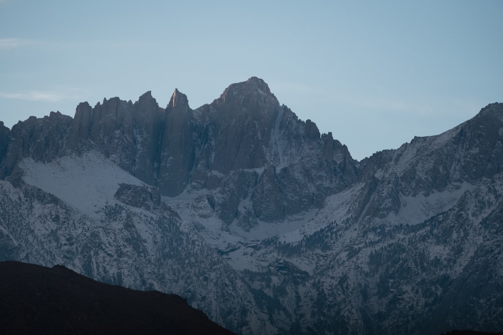 a view of a mountain range with snow on it