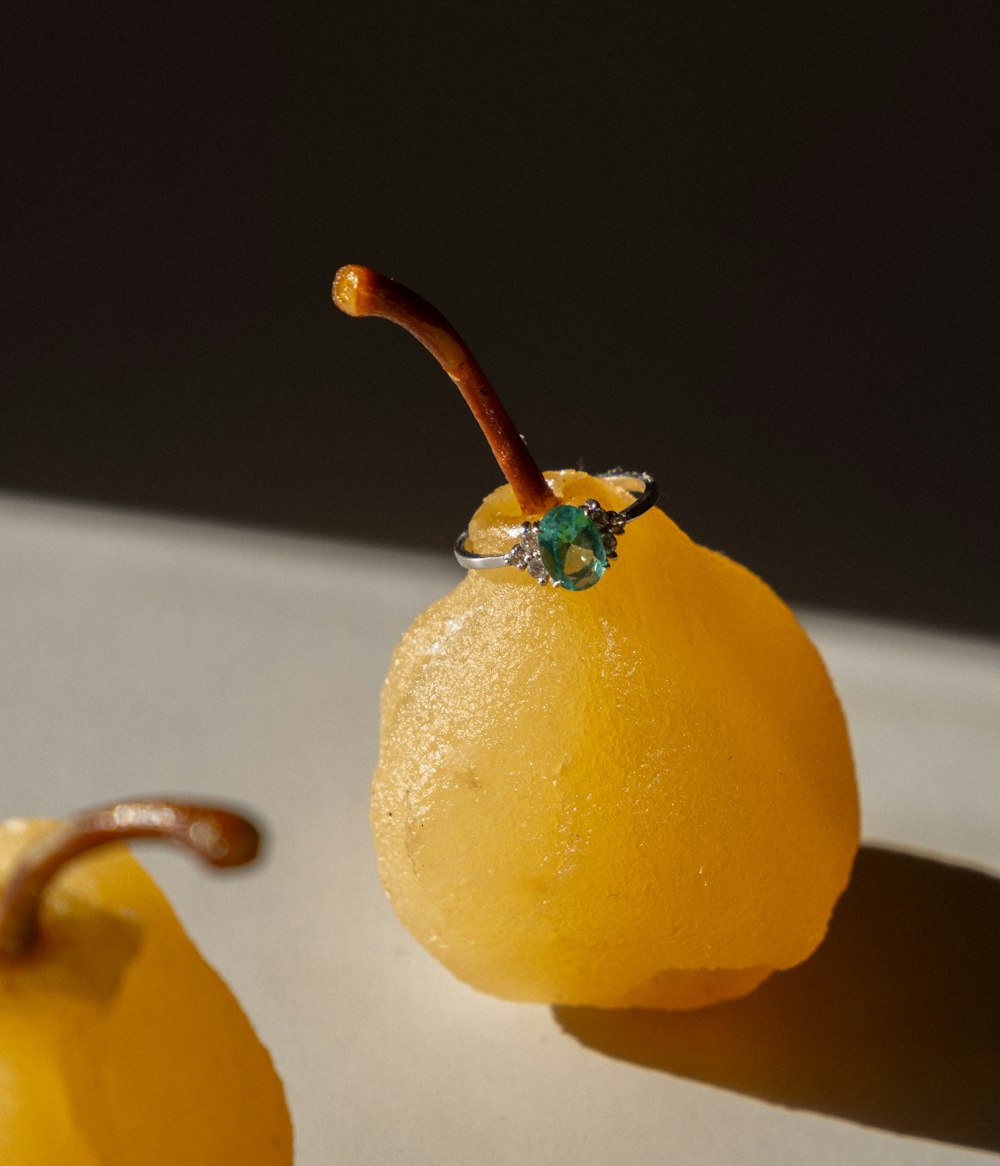 a close up of a fruit with a ring on it