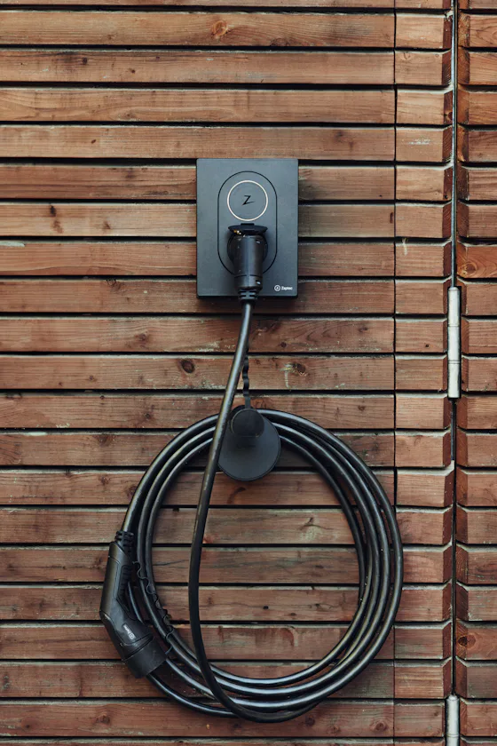 EV charging cable plugged into a wall-mounted charger
