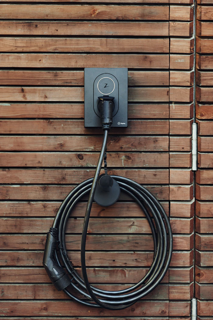 An EV charging cable mounted on a timber wall.