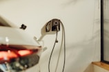a car plugged into a charger on a wall