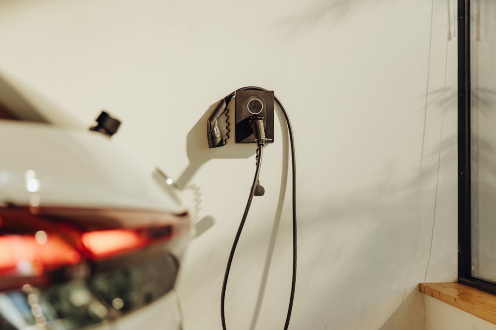 a car plugged into a charger on a wall