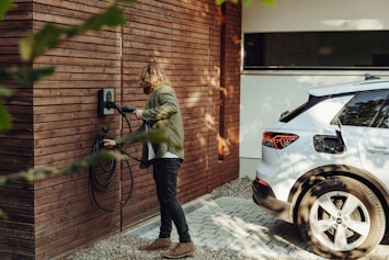a woman is using a power washer on a brick wall