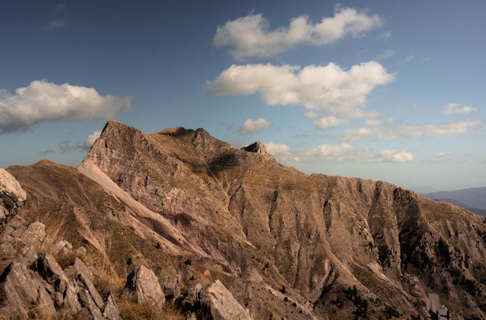 a view of a mountain range from the top of a hill