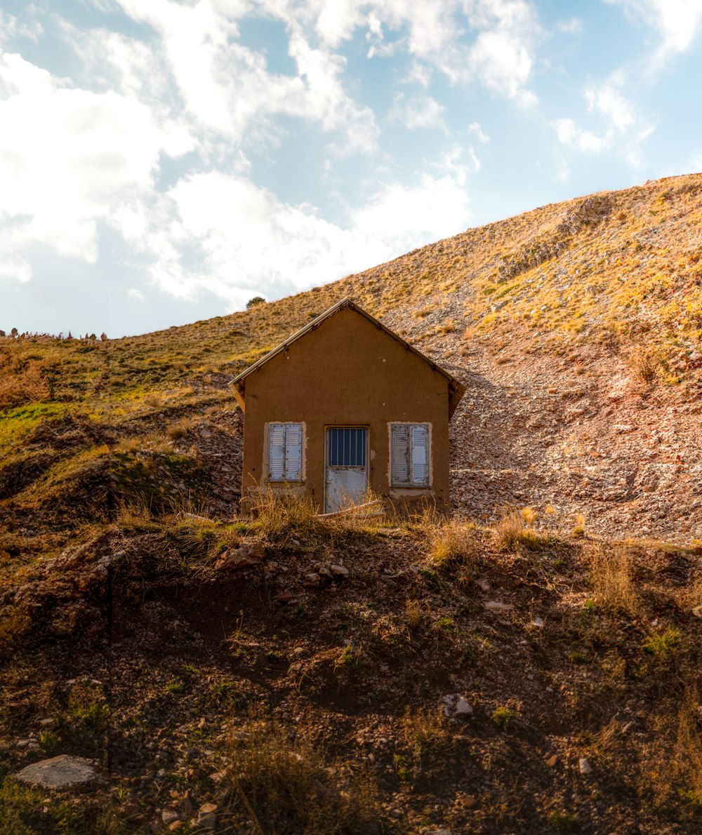 a small house sitting on top of a hill