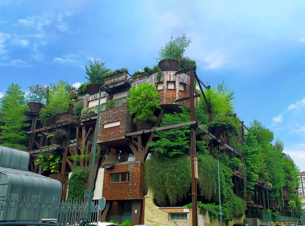 a very tall building with lots of plants growing on it