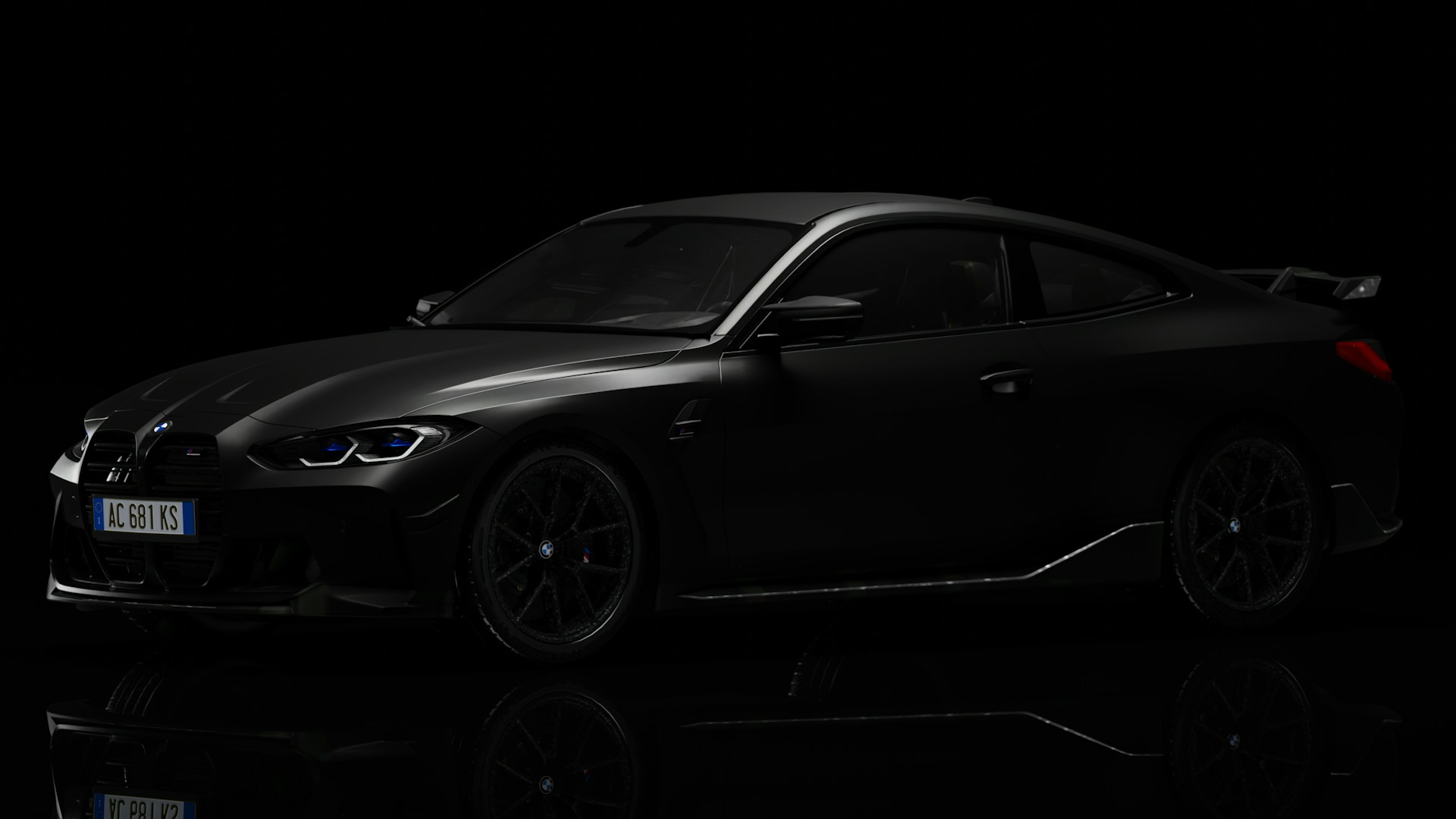 a black car is shown in the dark