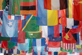 a bunch of flags hanging from a pole