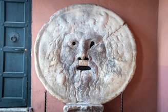a statue of a man with a beard on a wall